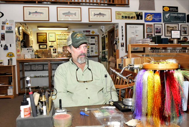 Bob Mallard, owner of Kennebec River Outfitters in Madison, speaks recently about the decline in trout fishing on the nearby Kennebec River and the negative impact on his business.