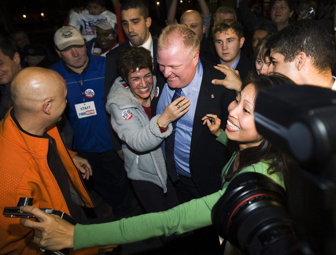 In this Monday, Oct. 25, 2010 photo, Toronto Mayor-elect Rob Ford, center, is greeted by a mob of supporters as he arrives to speak to supporters in Toronto. When he was elected, Ford’s bluster and checkered past were widely known. A plurality of voters backed him anyway, eager to shake things up at a City Hall they viewed as elitist and wasteful.