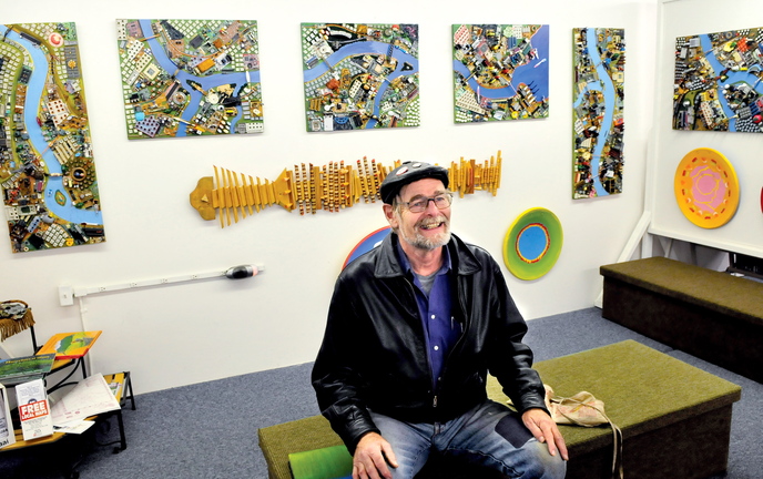 Artist Wally Warren speaks about his art including “City of Dreams,” which is exhibited behind him at the Central Maine Artists Gallery in Skowhegan on Thursday.