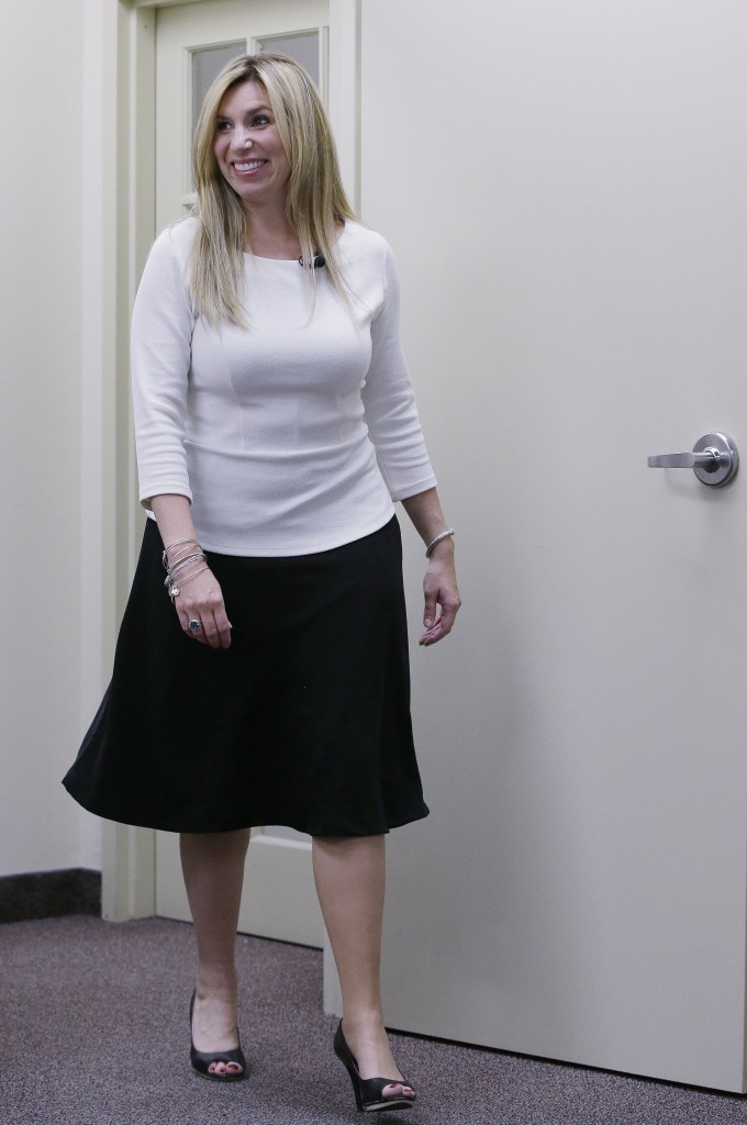 Sporting 4-inch-high heels, Heather Abbott of Newport, R.I., walks into a meeting wearing her new prosthetic leg. A company made the leg specifically to allow the self-dubbed “professional heel-wearer” to wear high heels.