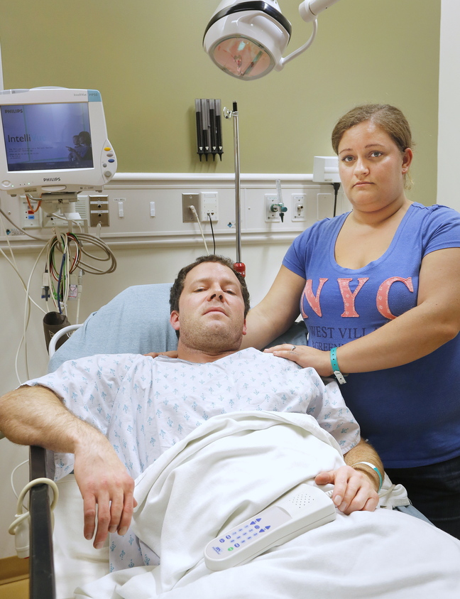 Casey Larcombe, shown at the hospital with his fiancee, Kathryn LePage, says a Toyota Carolla swerved into his family's car, sending it into the median strip on Interstate 295 on Wednesday.