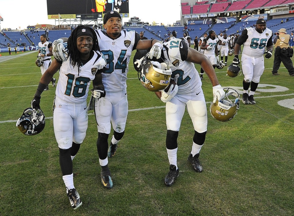 Jacksonville Jaguars players Ace Sanders (18), Cecil Shorts (84) and Mike Brown (12) celebrate as they leave the field after the Jaguars beat the Tennessee Titans 29-27 in an NFL football game on Sunday, Nov. 10, 2013, in Nashville, Tenn.