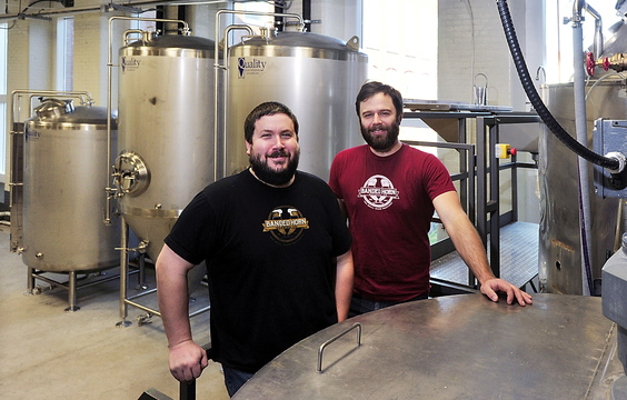 Ron Graves, left, and Ian McConnell stand amidst their stainless steel brewing equipment. They are set to open Banded Horn Brewing Co. as soon as this week. Biddeford’s first brewery since the 1700s, has received enthusiastic support from the local community.