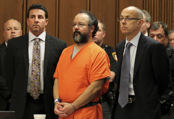 Ariel Castro, 53, stands between attorneys Craig Weintraub, left, and Jaye Schlachet as his sentence is read by Judge Michael Russo in the courtroom in Cleveland, Ohio, on Aug. 1. The judge sentenced Castro to life in prison for abducting, raping and holding captive three women for as long as 11 years, and murder for forcing one of the women to abort her pregnancy. Russo imposed the sentence after an emotional court hearing at which one of Castro’s victims, Michelle Knight, 32, said the former school bus driver put her through a life of hell.