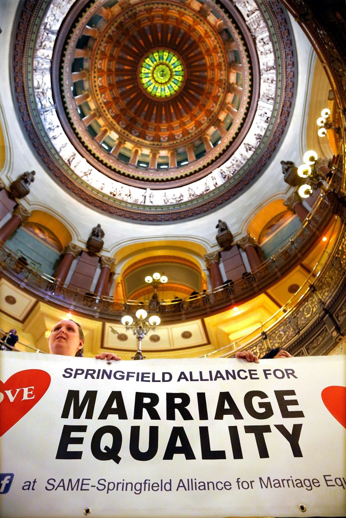 Supporters of same-sex marriage legislation rally in the rotunda at the Illinois State Capitol during a session Tuesday in Springfield Ill.