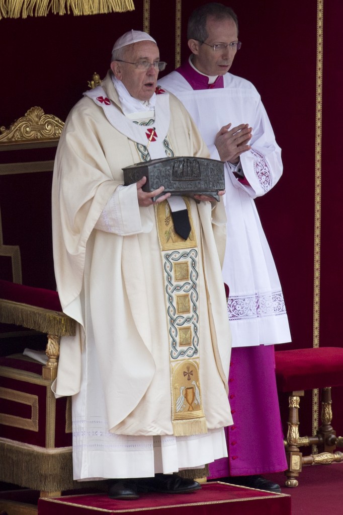 Pope Francis holds the relics of St. Peter as he celebrates Mass in St. Peter’s Square at the Vatican on Sunday.