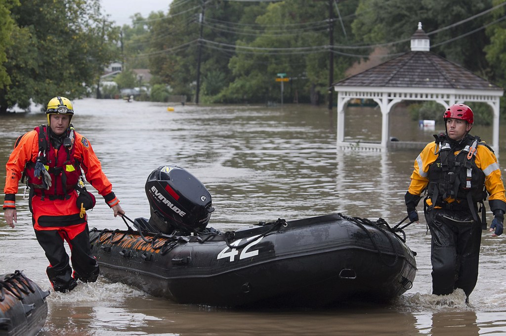 Fire rescuers go through a neighborhood in search of anyone in need in Austin, Texas, on Thursday, after heavy overnight rains brought flooding to the area.