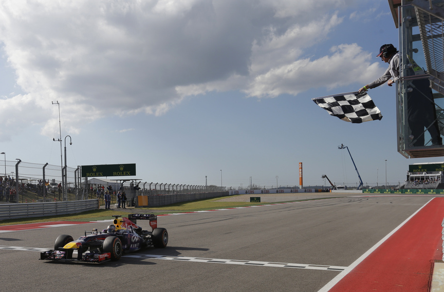 Red Bull driver Sebastian Vettel of Germany crosses the finish line to win the Formula One U.S. Grand Prix auto race at the Circuit of the Americas, Sunday, Nov. 17, 2013, in Austin, Texas.