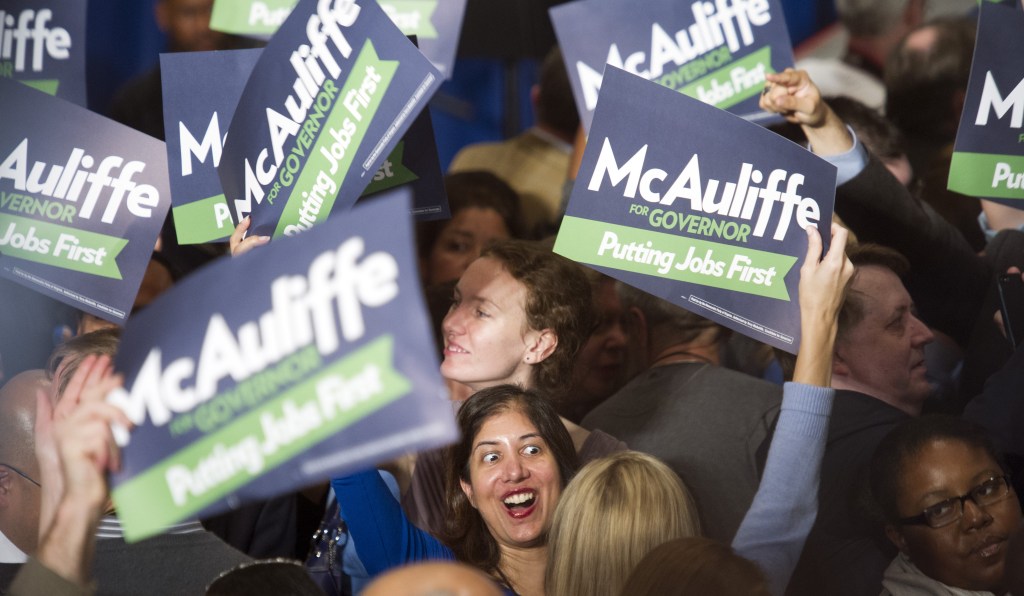 Supporters celebrate the news that Democratic gubernatorial candidate Terry McAuliffe has been elected the next Governor of Virginia during the election night party in Tysons Corner, Va., Tuesday, Nov. 5, 2013.