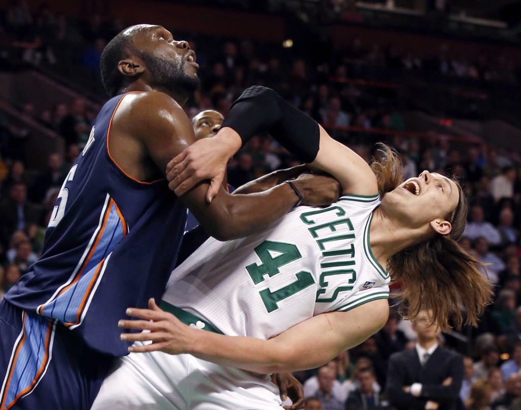 Al Jefferson, who had 22 points and 11 rebounds for the Charlotte Bobcats – fights for rebound position Wednesday night with rookie Kelly Olynyk of the Boston Celtics in the first period of Charlotte’s 89-83 victory that ended Boston’s four-game winning streak.