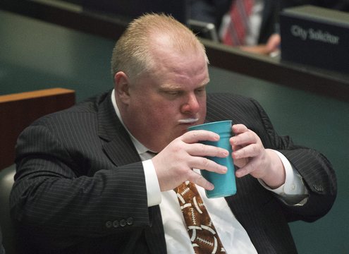 Toronto Mayor Rob Ford displays a milk moustache at the City Council meeting Thursday. He denied he pressured a female staffer for sex, in an obscenity-laced statement on live television.