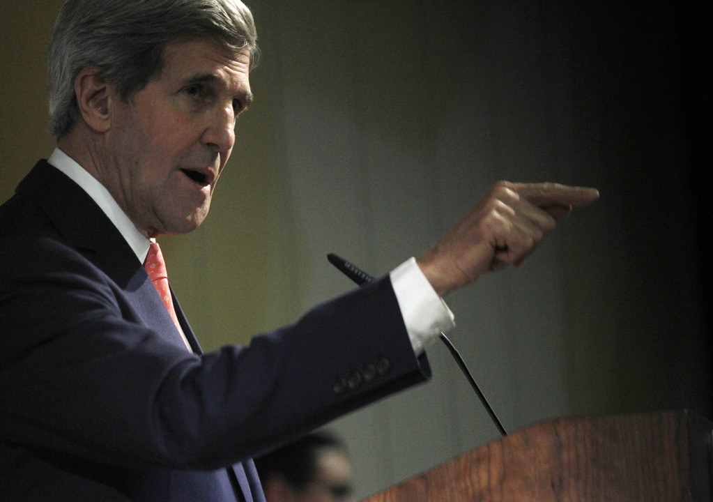 U.S. Secretary of State John Kerry gestures Sunday in Dubai while discussing the latest round of negotiations seeking to limit Iran’s uranium enrichment.