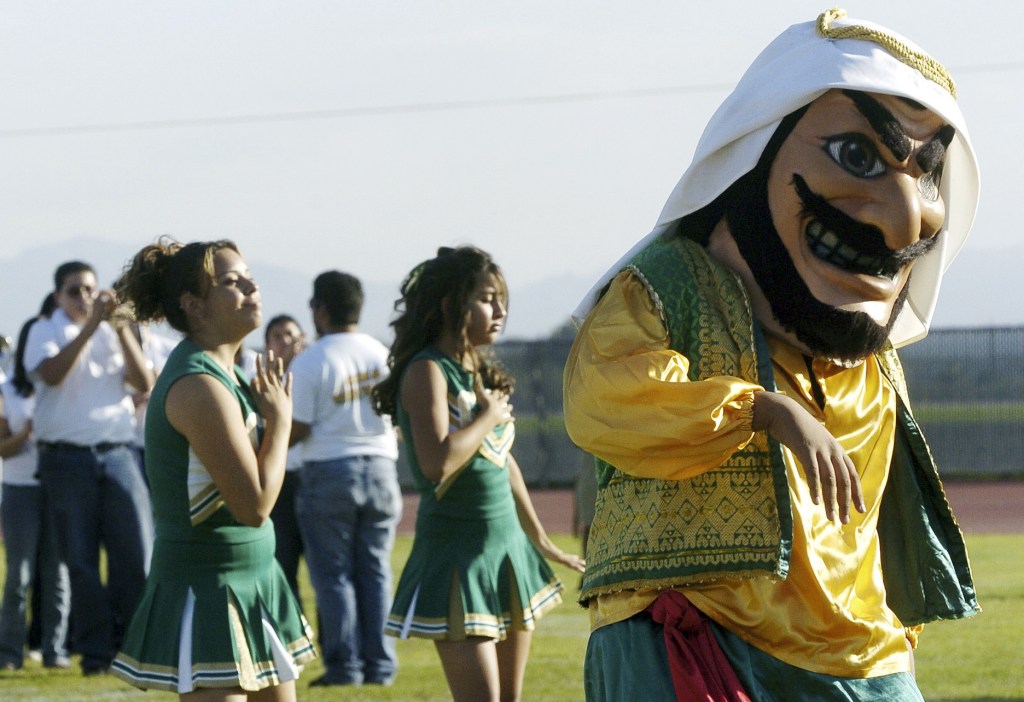 Coachella Valley High School’s mascot, “Arab,” dances to the band during a pep rally at the school in Thermal, Calif. School officials in Southern California say the ‘Arabs’ are here to stay, but the costumed mascot that represents them may be changing.