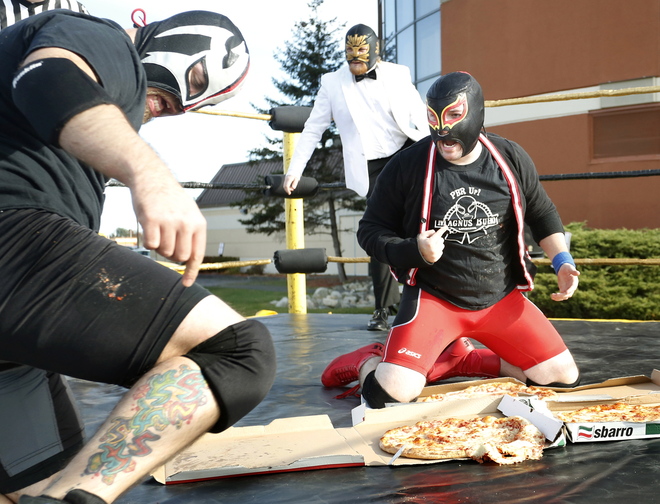Jacob Cote and Antoine Malaab argue about who won their pizza party wrestling match after they both slammed each other onto the pizza at the Coast City Comicon convention at the Double Tree Hilton in South Portland on Saturday. Both were declared winners.