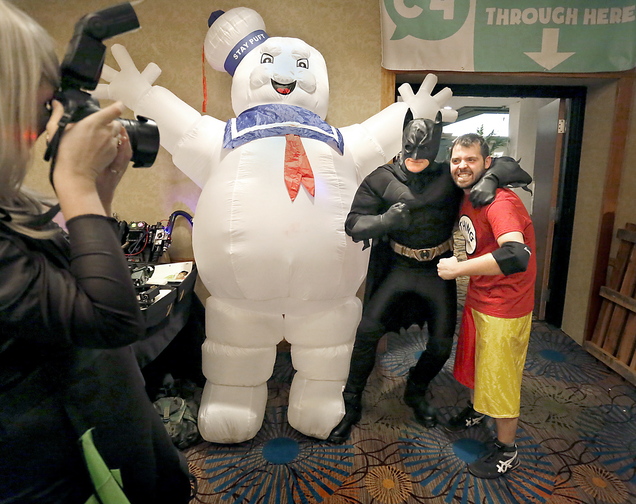 Alex Lear of North Yarmouth, dressed as Batman, poses for a picture with Nate Speckman of Portland next to the Stay Puft Marshmallow Man during the Coast City Comicon convention at the Double Tree Hilton in South Portland on Saturday afternoon.