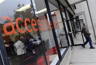 A man leaves Access Health CT, Connecticut’s health insurance exchange’s first insurance store, on Thursday in New Britain, Conn. The site, which people can visit to sign up for coverage, is the first in the nation.
