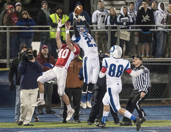 Liam Studley of Kennebunk, 23, breaks up a pass intended for Jonathan Saban of Cony in the first half of their Class B state championship game Friday night. Saban came back to haul in the winning touchdown pass with a minute remaining as Cony emerged with a 30-23 victory at Orono.