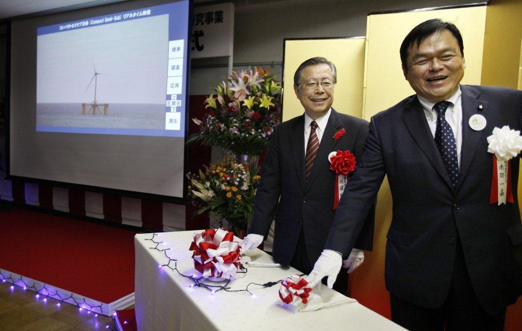 Japan's State Minister of Economy, Trade and Industry Kazuyoshi Akaba, right, and Fukushima Gov. Yuhei Sato push the start button during the launch ceremony of Fukushima Floating Offshore Wind Farm Demonstration Project in Iwaki, Fukushima Prefecture, northeastern Japan, Monday, Nov. 11, 2013. Japan switched on the first turbine at a wind farm 20 kilometers (12 miles) off the coast of Fukushima on Monday, feeding electricity to the grid tethered to the tsunami-crippled nuclear plant onshore. The wind farm near the Fukushima Dai-Ichi nuclear power plant is to eventually have a generation capacity of 1 gigawatt from 143 turbines, though its significance is not limited to the energy it will produce. (AP Photo/Koji Sasahara)