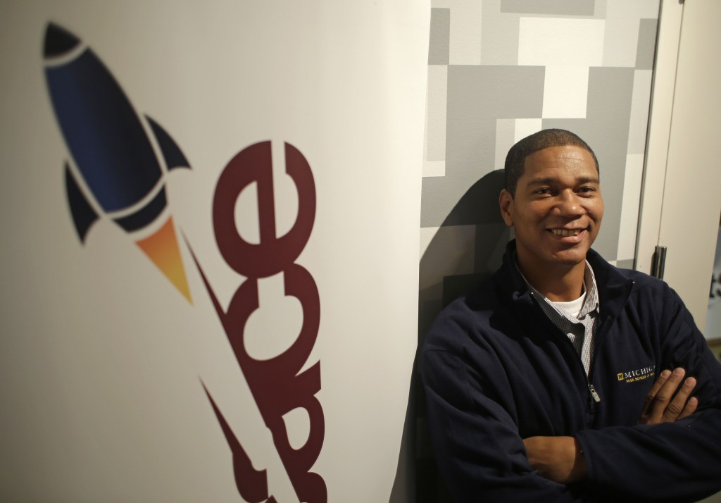 Kenyatta Leal, a former prison inmate, poses outside the office at Rocket Space in San Francisco, where he joins a team of engineers and designers on the same career path, but with drastically different stories of how they got there.