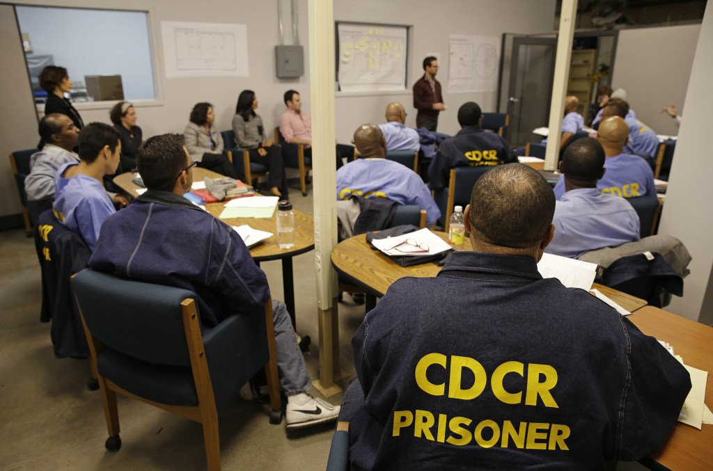 Inmates listen as Andrew Kaplan, a product marketing manager at Linkedin, leads a session of The Last Mile at San Quentin State Prison recently. The Last Mile program trains selected prisoners for eventual employment in a paid internship program within the Silicon Valley technology sector.