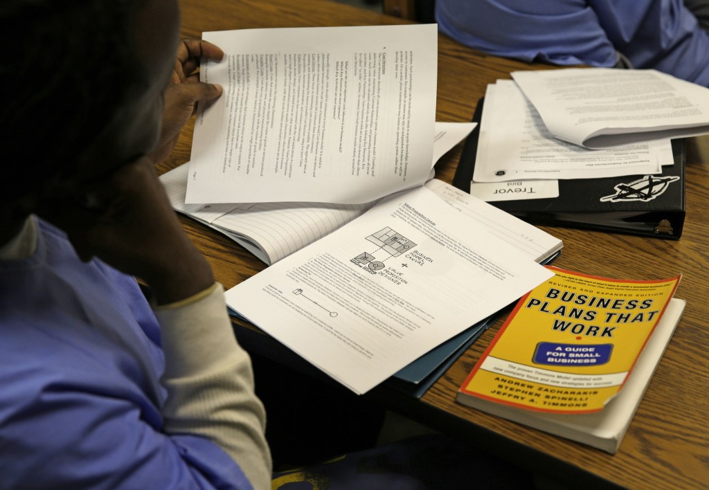 An inmate looks over materials on a business model canvas during a session of The Last Mile at San Quentin State Prison in San Quentin, Calif. Through twice-weekly sessions, the program provides information and practical experiences to foster inmates’ confidence and a sense of hope that they can succeed as free men.