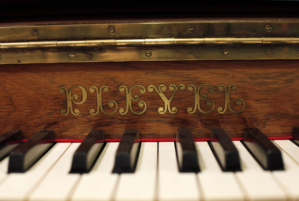 A Pleyel piano is displayed in a piano store, in Paris, Saturday, Nov. 16, 2013. Gone are its glory days, when Chopin composed concertos on its pianos. Franceís Pleyel piano maker is shutting its doors, unable to keep up with cheaper and more agile competition.