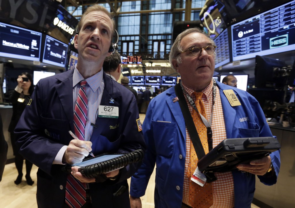 Traders Michael Smyth, left, and Eugene Mauro work on the floor of the New York Stock Exchange on Thursday.