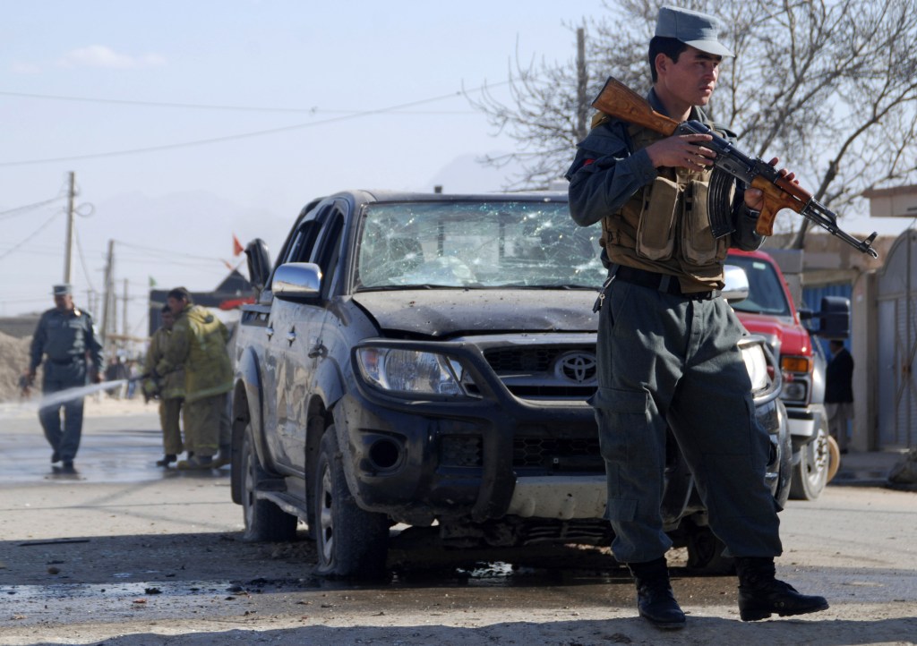An Afghan policeman secures the area where a suicide bomber attacked the deputy governor of Balkh province in Mazar-e-Sharif, northern Afghanistan, on Sunday While the official escaped unhurt, at least one civilian was killed, said Balkh police spokesman Sher Jan Durrani.