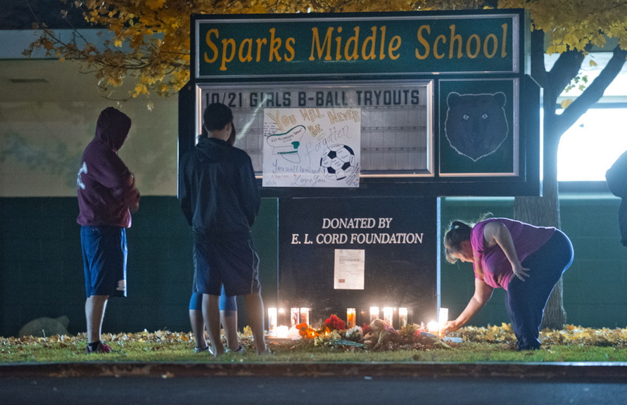 Community members pay their respects to Michael Landsberry, a 45-year-old eighth-grade math teacher, soccer coach and former Marine who was killed by a student at Sparks Middle School on Oct. 21 in Sparks, Nev.