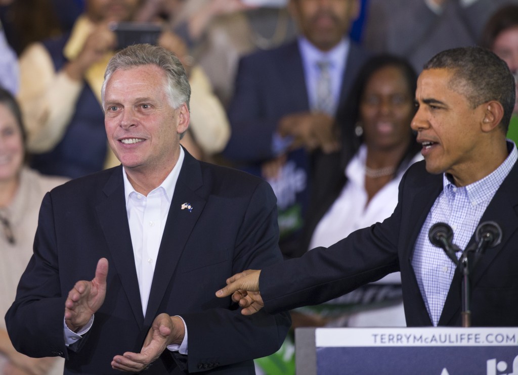 President Obama points to Virginia Democratic gubernatorial candidate Terry McAuliffe as they appear at a McAuliffe campaign rally at Washington Lee High School in Arlington, Va., Sunday. Democrats hope Obama’s public backing of McAuliffe will excite the base in Virginia.