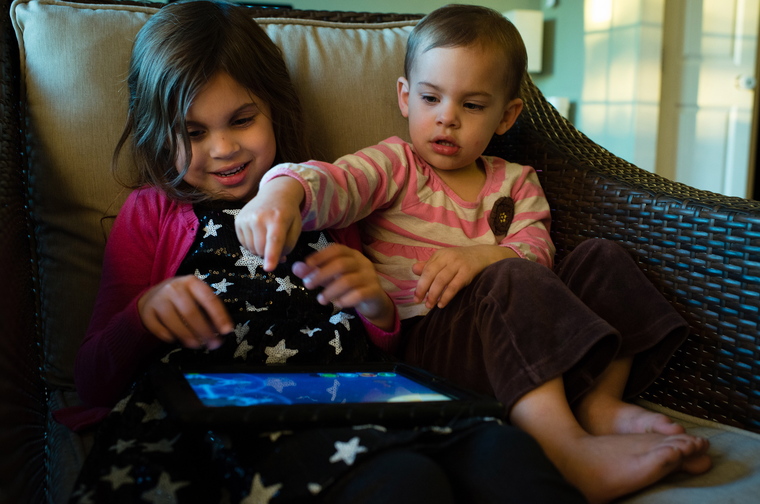 Kaylie Zaal, 5, left, and her little sister Reagan Zaal, 2, play on an iPad at their home in Middletown, Md. Manufacturers are racing to tap into the market for kid-friendly tablets.