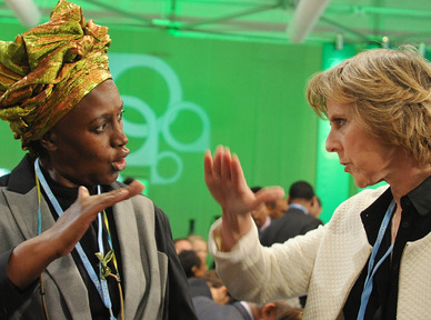 Alice Akinyi Kaudia of Kenya, left, talks with European Climate Commissioner Connie Hedegaard at the U.N. climate change conference in Warsaw, Poland, last week. Hedegaard said Sunday that the international conference ought to provide a “substantial answer” to global warming by 2015.