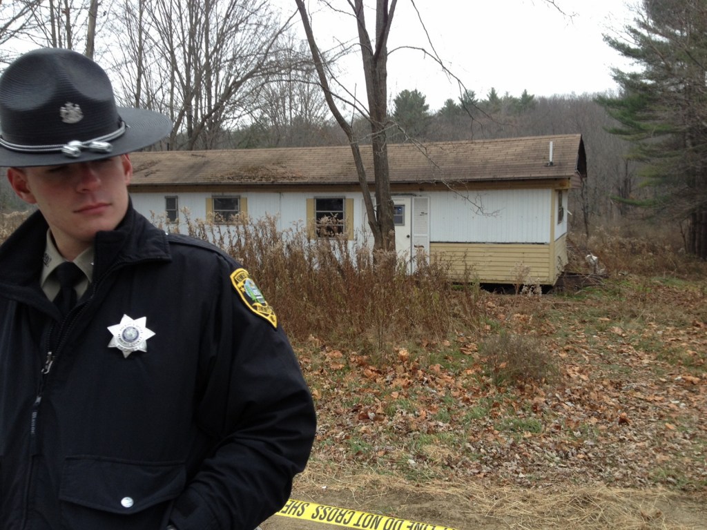 Kennebec County Sheriff’s Deputy Aaron Moody guards the property at 2349 Riverside Drive in Vassalboro on Friday morning after a man was found dead there.