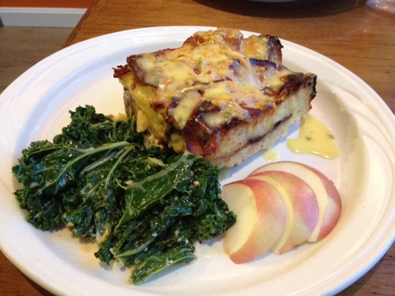 Leaven’s bread pudding entree is served with the vegetable of the day and apple slices.