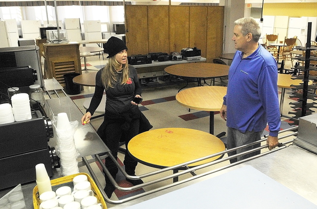 Angela Cummings, left, and Scott Scholl discuss what price to mark on cafeteria equipment Wednesday as Centurion workers prepare for this weekend’s public sale at the former MaineGeneral Medical Center in Augusta.