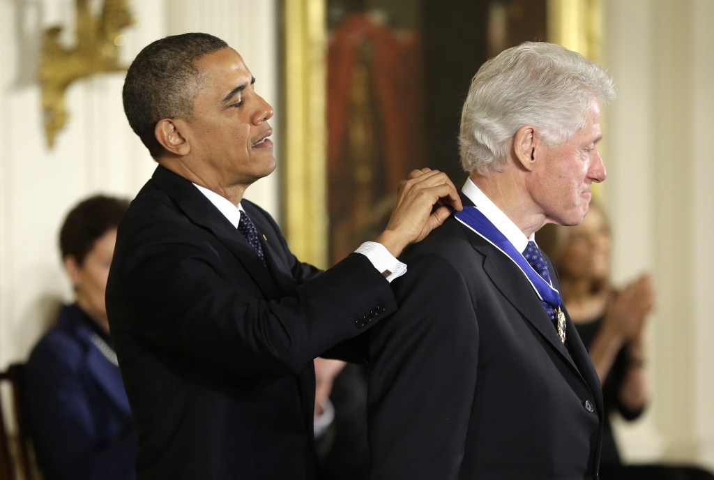 President Barack Obama awards former President Bill Clinton the Presidential Medal of Freedom on Wednesday during a ceremony in the East Room of the White House.
