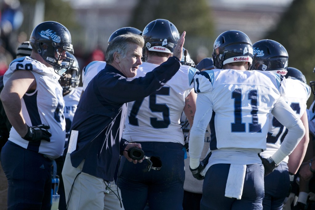Maine Coach Jack Cosgrove pats the shoulder of Maine wide receiver John Ebeling in Saturday’s loss to New Hampshire. The Black Bears received a firt-round bye in the Football Championship Subdivision playoffs and will be home for a playoff game for the first time on Dec. 7.