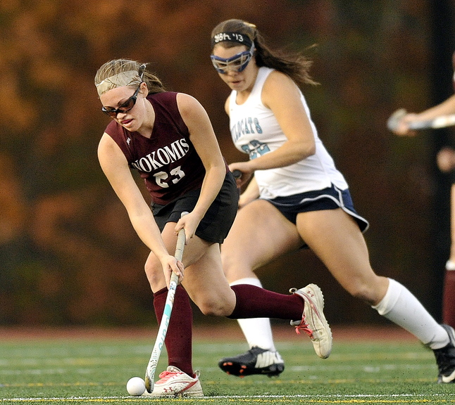 Taylor Shaw of Nokomis moves with the ball in front of York’s Madeline Leroux during first half action in the Class B field hockey championship at Yarmouth High School Saturday, November 2, 2013.