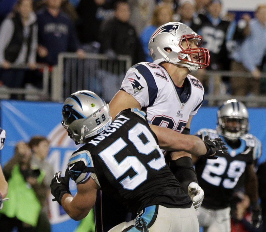 Luke Kuechly, 59, blocks Rob Gronkowski of the Patriots on the final play Monday night. A penalty flag was thrown for pass interference, but after a brief huddle, the officials waved off the penalty and the Panthers won, 24-20.