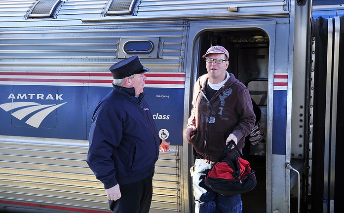 Bryant Witham of Brunswick disembarks Wednesday from the Downeaster in Portland. Witham, a plumber, says he often takes the train to work in Portland because it’s fast, punctual and saves money.