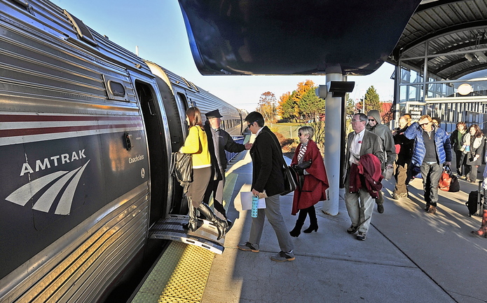 Conductor Brian Labreck greets passengers heading to Boston and stops in between as they board the Downeaster in Portland on Wednesday morning. Two of the five daily Portland-Boston trips extend to Brunswick.