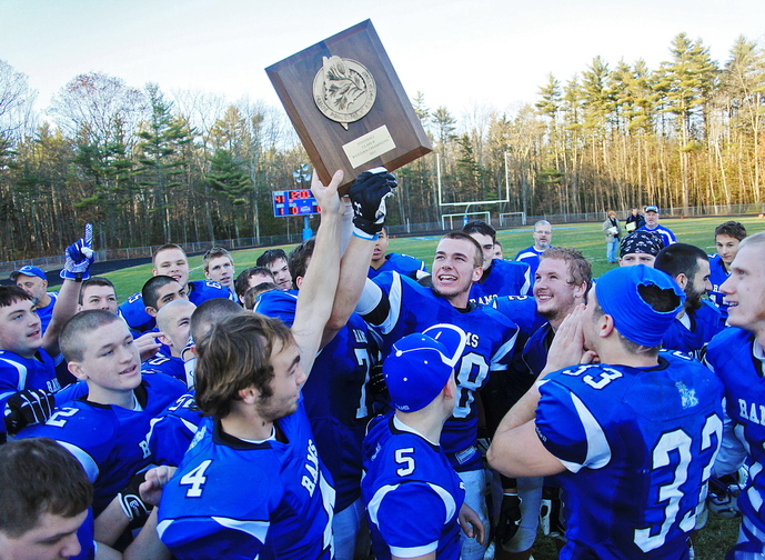 Kennebunk #88, Austin Sandler, center, and his teammates hold up their trophy while celebrating their win over Marshwood in the Western Class B regional final at Kennebunk High School Saturday, Nov. 16, 2013. Jill Brady/Staff Photographer.