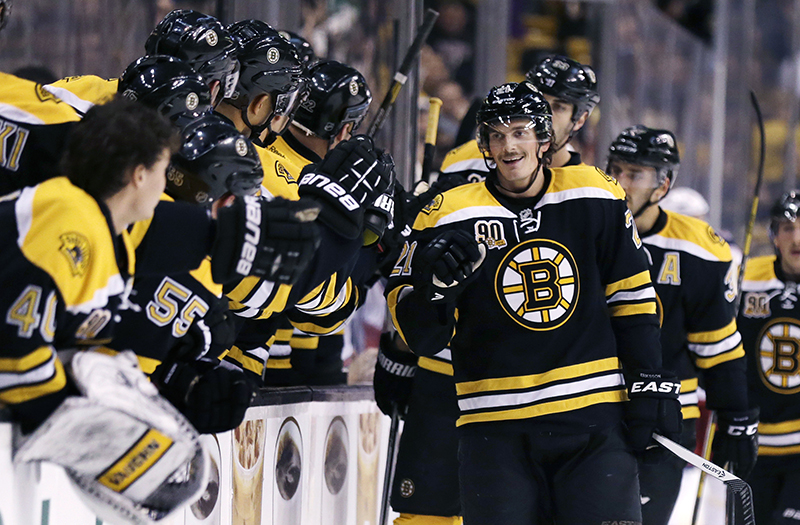 Boston Bruins left wing Loui Eriksson is congratulated by teammates after his goal against the Columbus Blue Jackets during the first period of an NHL hockey game, in Boston, Thursday, Nov. 14, 2013. (AP Photo/Charles Krupa)