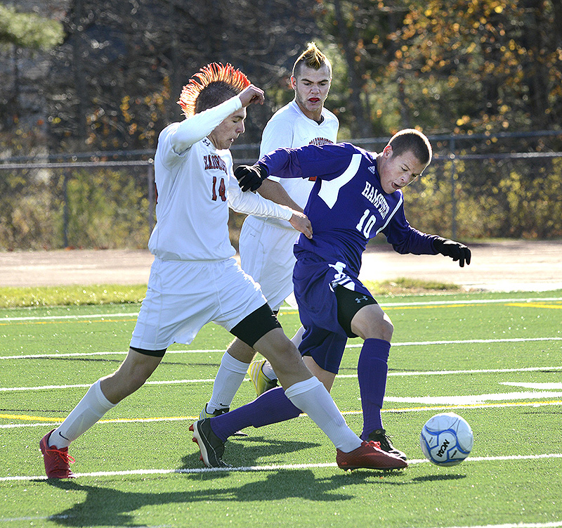 Scarborough’s Max Ornstein, left, and Hampden Academy’s Benjamin Foster fight for the ball during the Class A boys’ soccer state championship on Saturday. BoysAsoccer