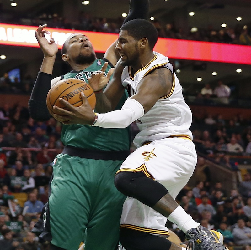 Boston Celtics' Jared Sullinger, left, blocks Cleveland Cavaliers' Kyrie Irving in the second quarter of an NBA basketball game in Boston, Friday, Nov. 29, 2013.