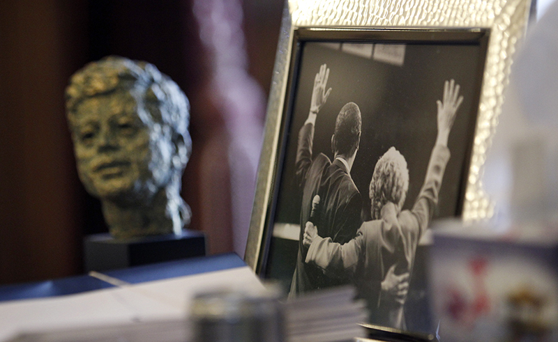 In this Dec. 11, 2012 file photo, a bust of former U.S. President John F. Kennedy sits on the desk of Gov. Chris Gregoire near a photo of Gregoire and U.S. President Barack Obama, in Olympia, Wash. Lisa Pease, a researcher who has studied 1960s assassinations extensively, said at an October 2013 assassination symposium in Pittsburgh, "We have to know the truth of our past and our present, in order to make good decisions about our future."