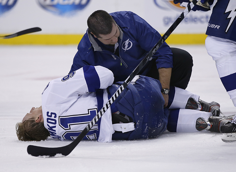 Tampa Bay Lightning center Steven Stamkos is attended to on the ice after banging into the goalpost during the second period of an NHL hockey game against the Boston Bruins in Boston Monday, Nov. 11, 2013. Stamkos was taken off the ice on a stretcher after the play. (AP Photo/Elise Amendola) TD Garden