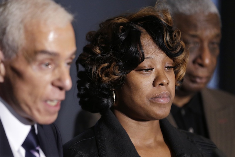 Monica McBride, center, is seen with attorney Gerald Thurswell, left, and spokesman Ron Scott, right, during a news conference in Southfield, Mich., Friday, Nov. 15, 2013. Monica's daughter, Renisha McBride, was shot on Nov. 2 in the face on Theodore P. Wafer's front porch in Dearborn Heights.