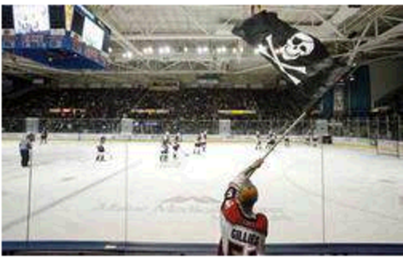 Dan Bailey of Yarmouth waves the Jolly Roger during a game between the Portland Pirates and Manchester Monarchs at the Cumberland County Civic Center in 2010. The arena’s trustees and the team’s owners should resume talks to resolve a stalemate over the Pirates’ lease.