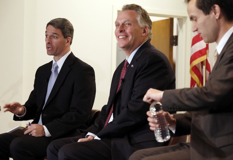 Candidates for the Virginia governor seat Ken Cuccinelli, left, Terry McAuliffe, center, Robert Sarvis, right, participate in a community forum at the Virginia War Memorial in Richmond, Va., on Saturday, Oct. 26, 2013.